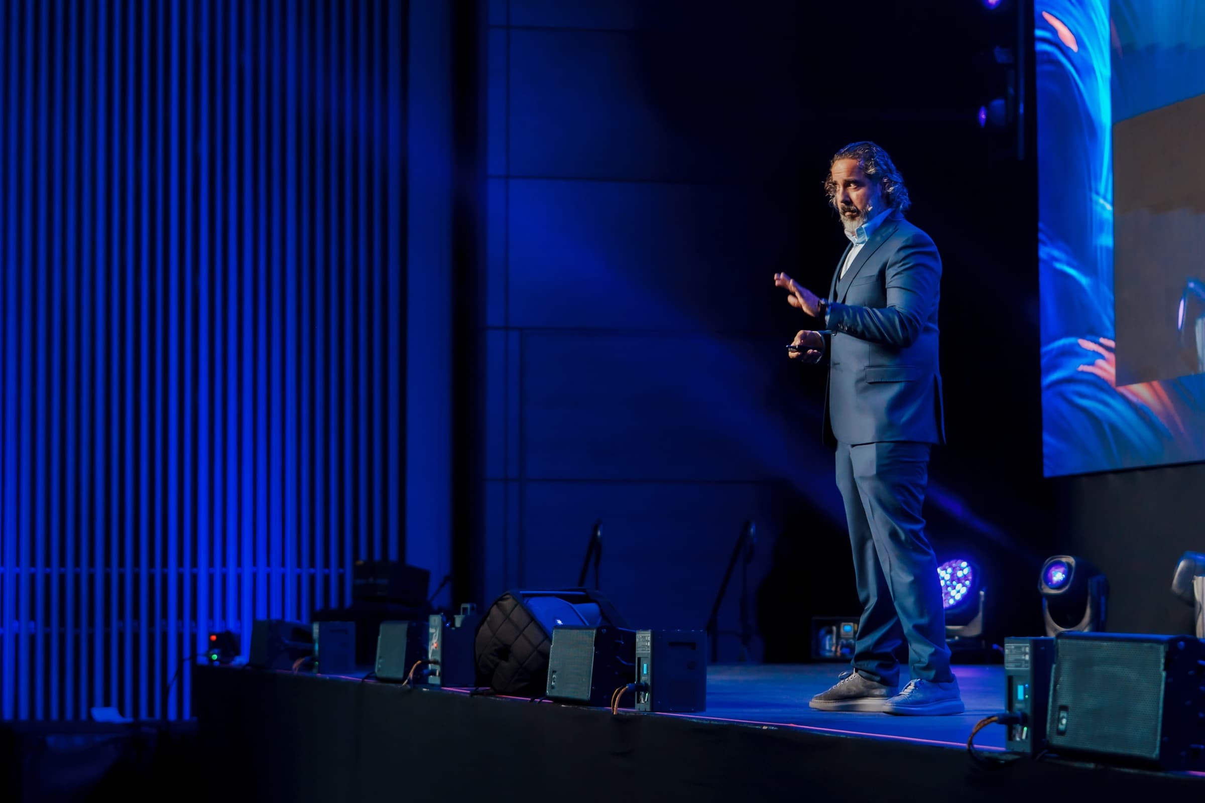 Manuel commanding the stage in blue light at Game Changers Fest