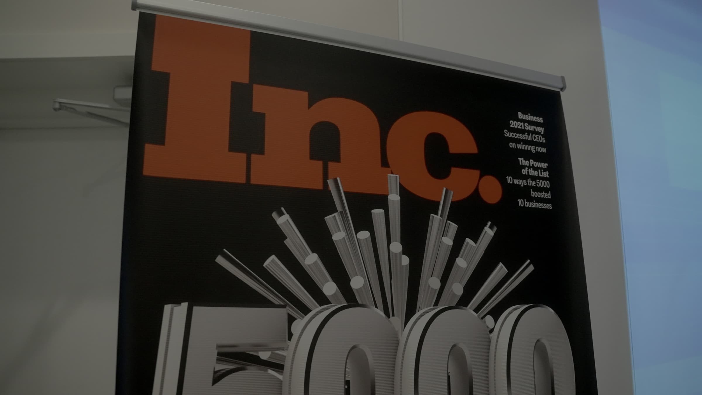 The Inc. magazine honoree banner standing in the AGM office
