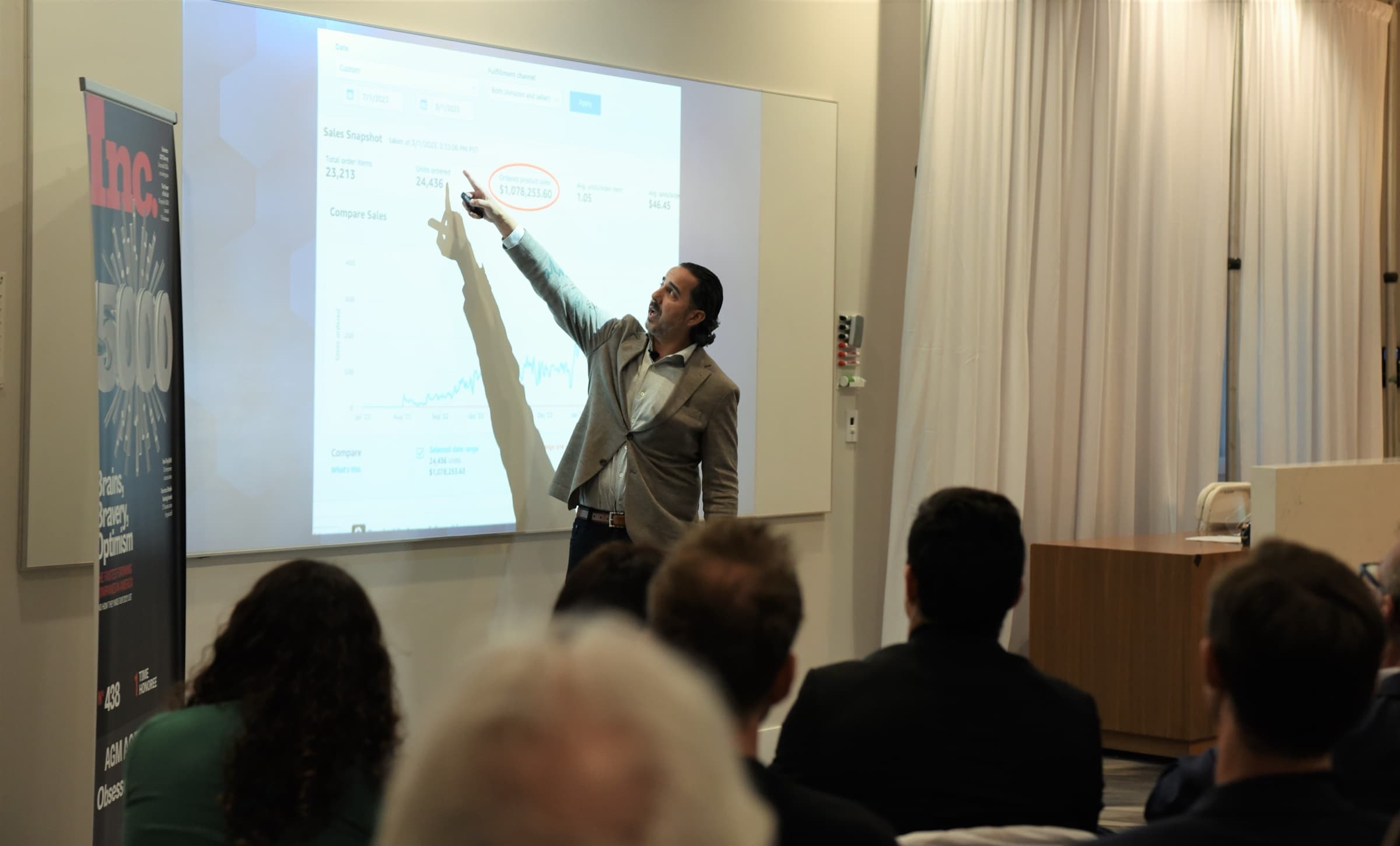 Manuel Suarez pointing at a projected slide mid-session
