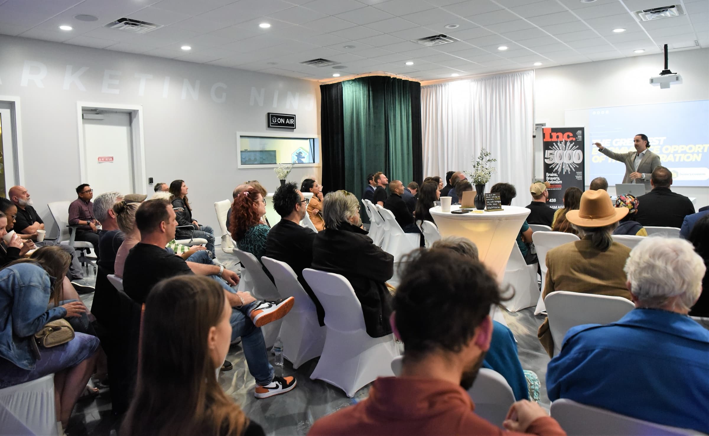 Manuel Suarez gesturing over a full room at an AGM workshop