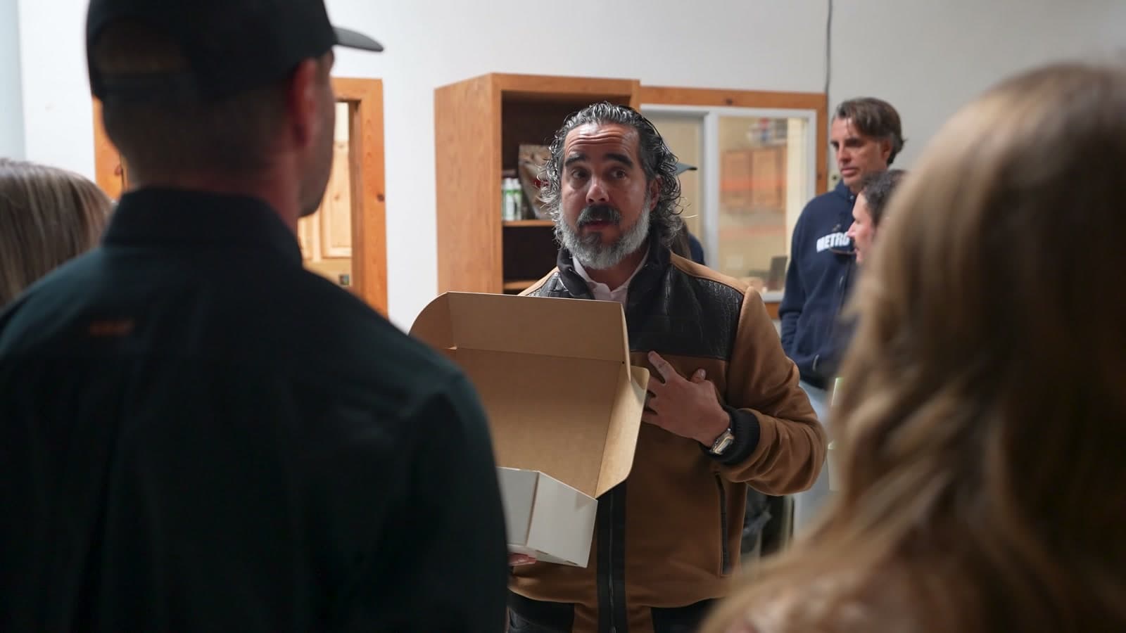 Manuel opens a Better Dog shipment box at the brand's manufacturing facility